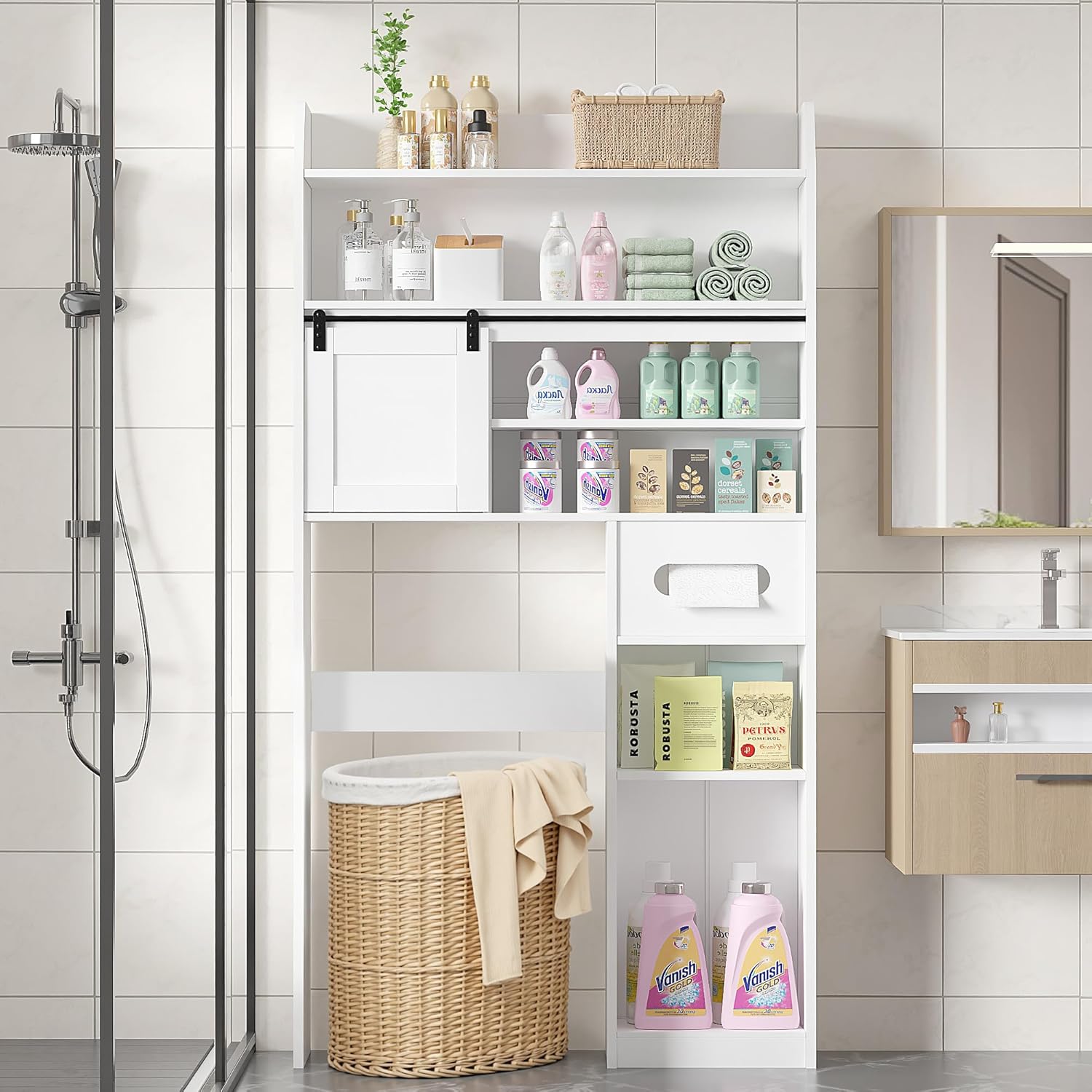 Over the Toilet Storage Cabinet in a Modern Bathroom – White multifunctional bathroom shelf with sliding door, towel storage, and laundry hamper below. Space-saving solution for small bathrooms.