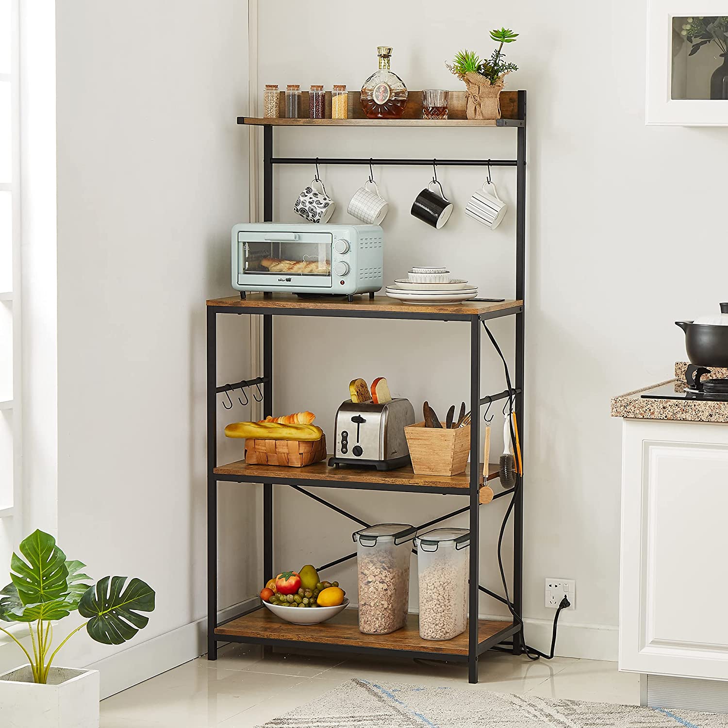 Freestanding baker’s rack with power outlets and open shelving, ideal for small kitchen storage and countertop appliance setup.