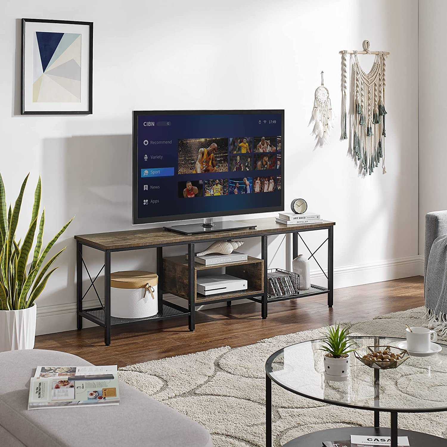 Modern living room with a wood-and-metal TV stand holding a flat-screen TV, featuring open shelves for storage and decorative accents around the space.